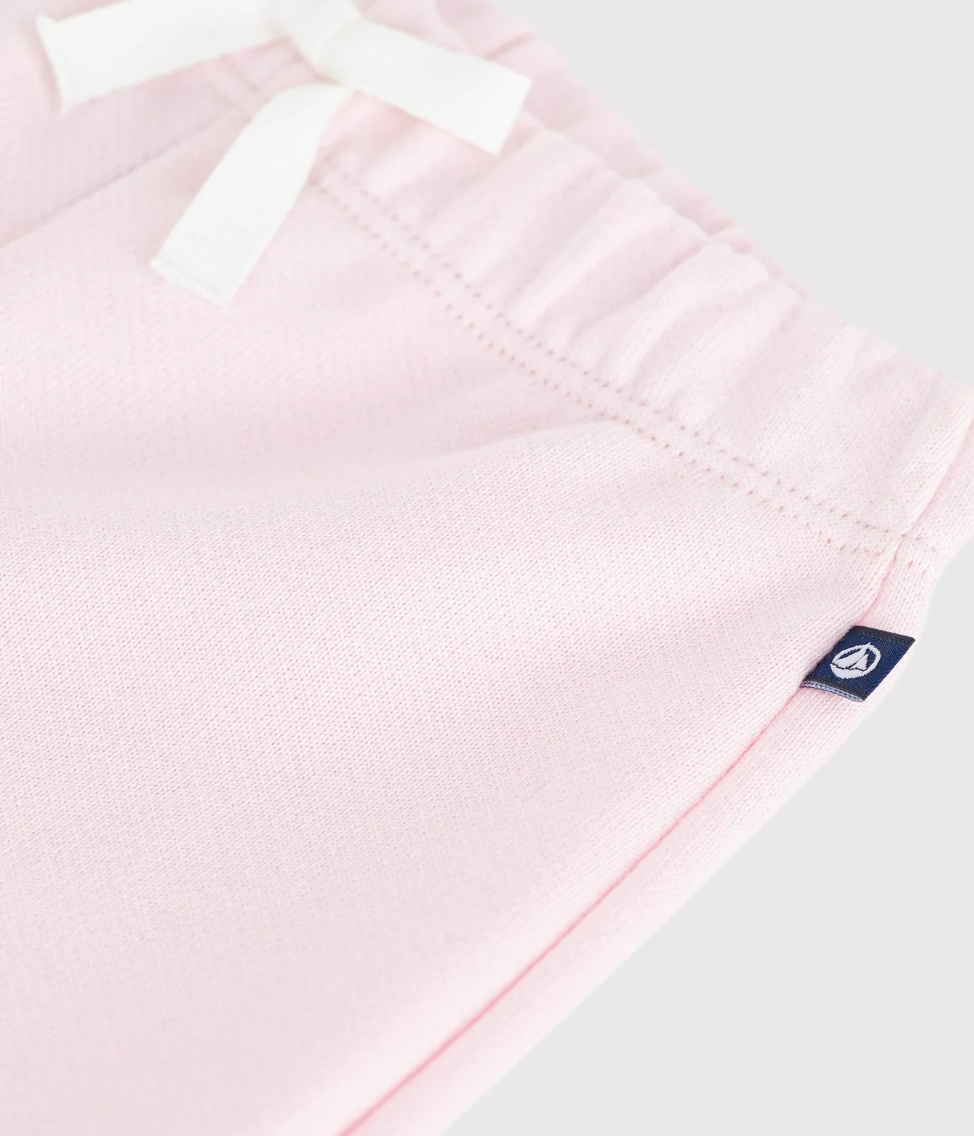 Babies' jogging bottoms in plain cotton