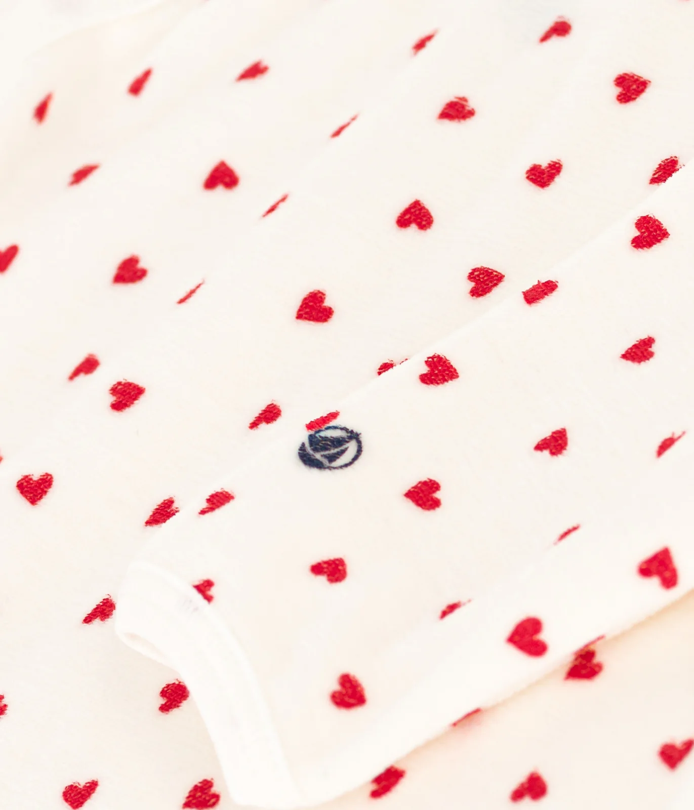 Unisex baby sleepsuit in Velour with a small heart print