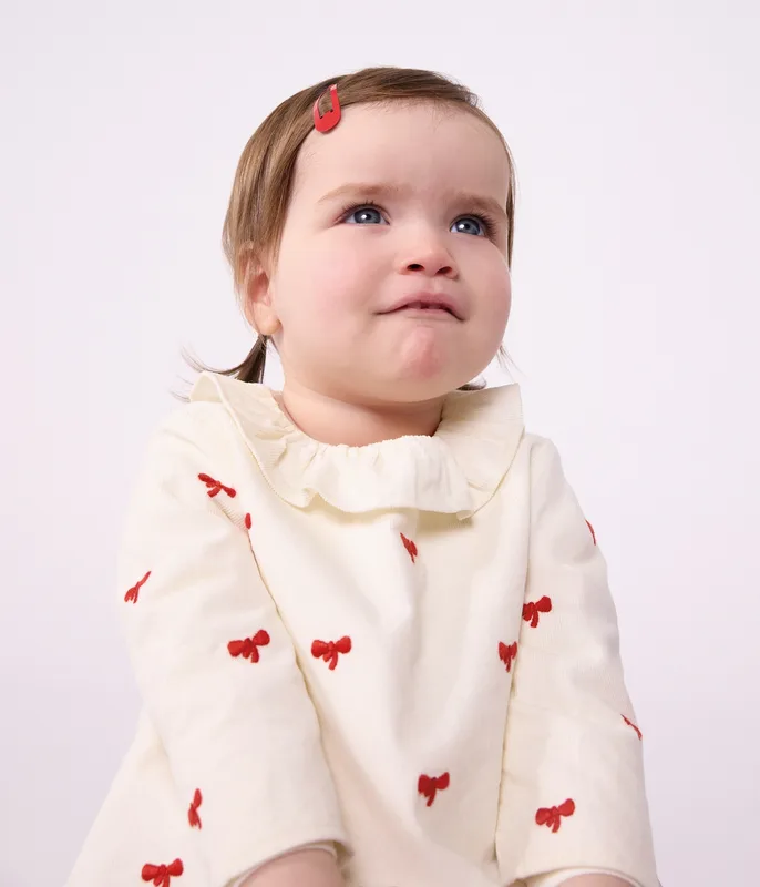 Babies' blouse in velour embroidered with a bow motif