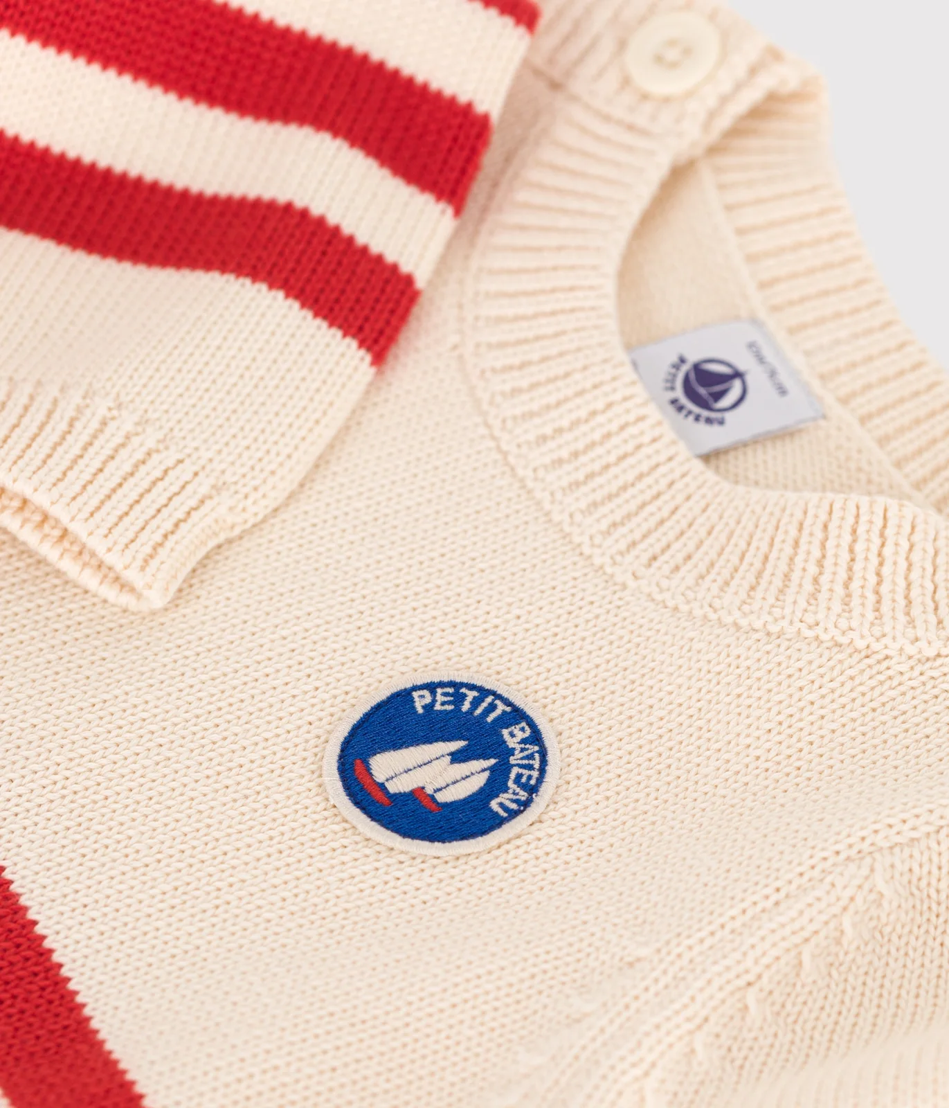 Babies' cotton jumper with placed stripes and a badge on the chest