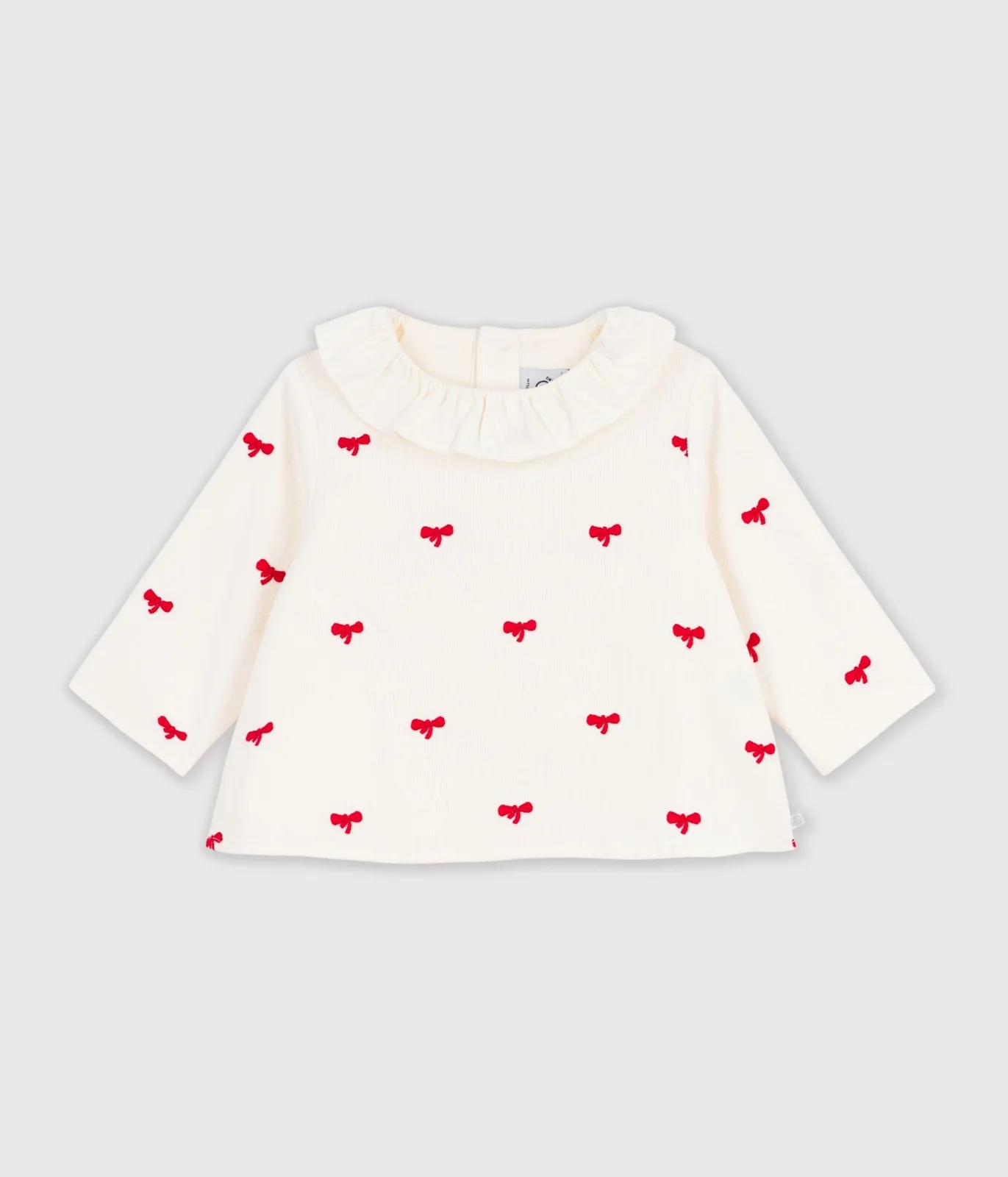 Babies' blouse in velour embroidered with a bow motif