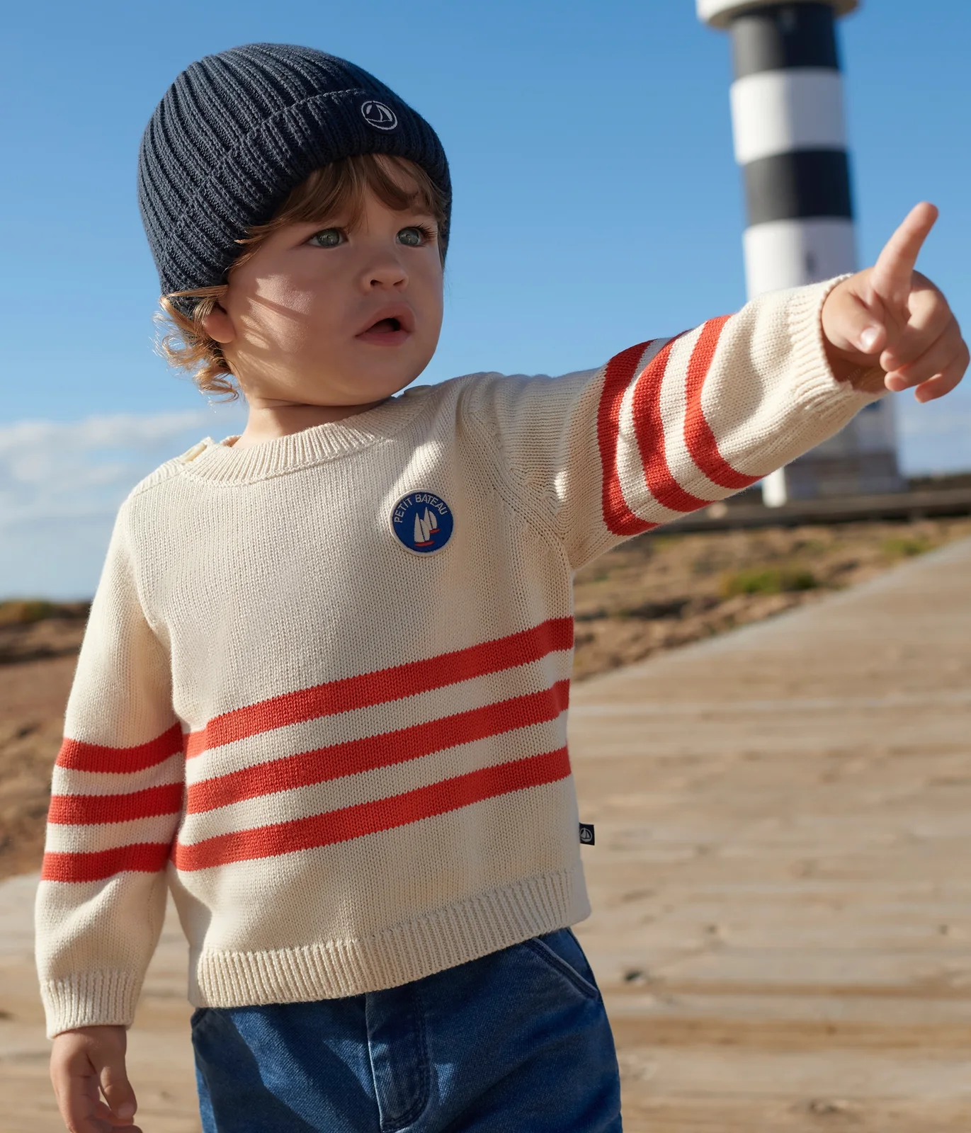 Babies' cotton jumper with placed stripes and a badge on the chest