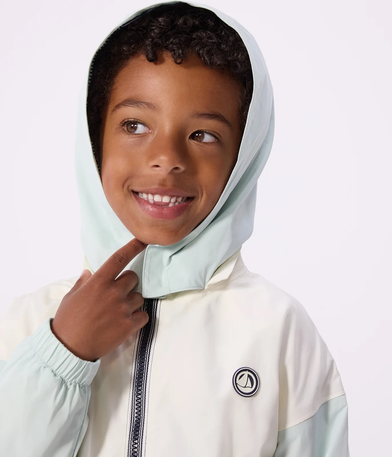 Children's windbreaker with a retractable hood