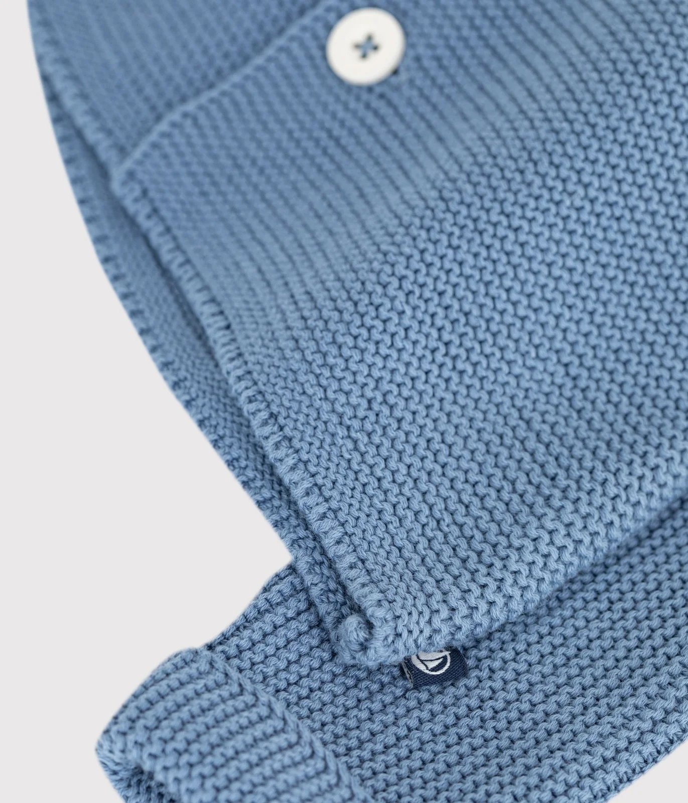 Baby cardigan knitted in garter stitch in plain cotton