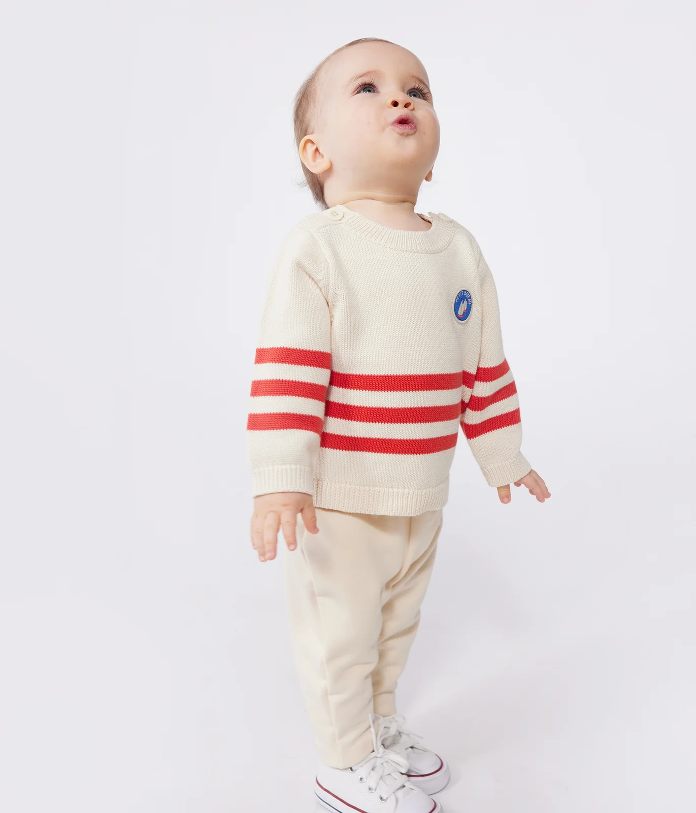 Babies' cotton jumper with placed stripes and a badge on the chest
