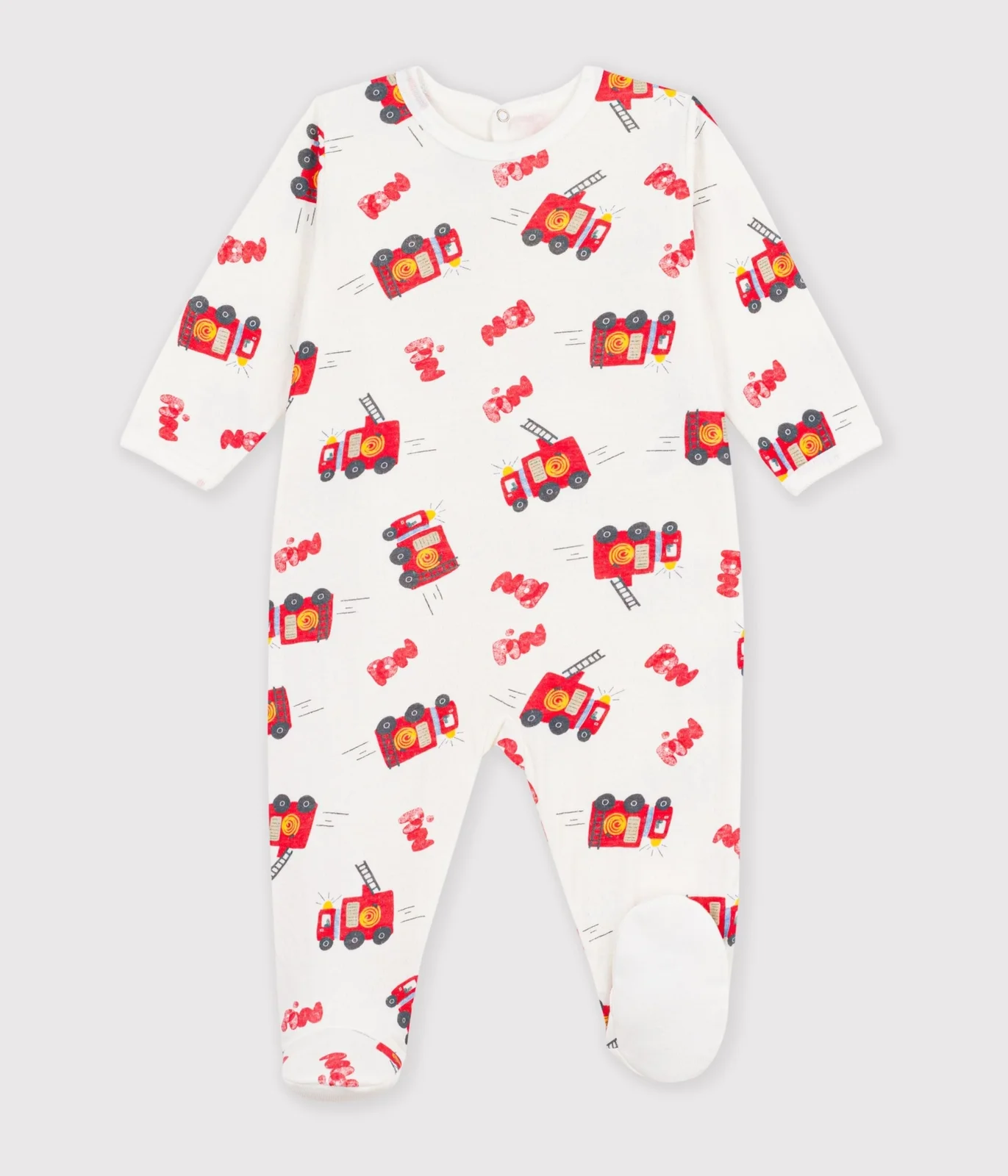 Babies' pyjama suit in tube knit fabric with a printed firefighter design and a back opening